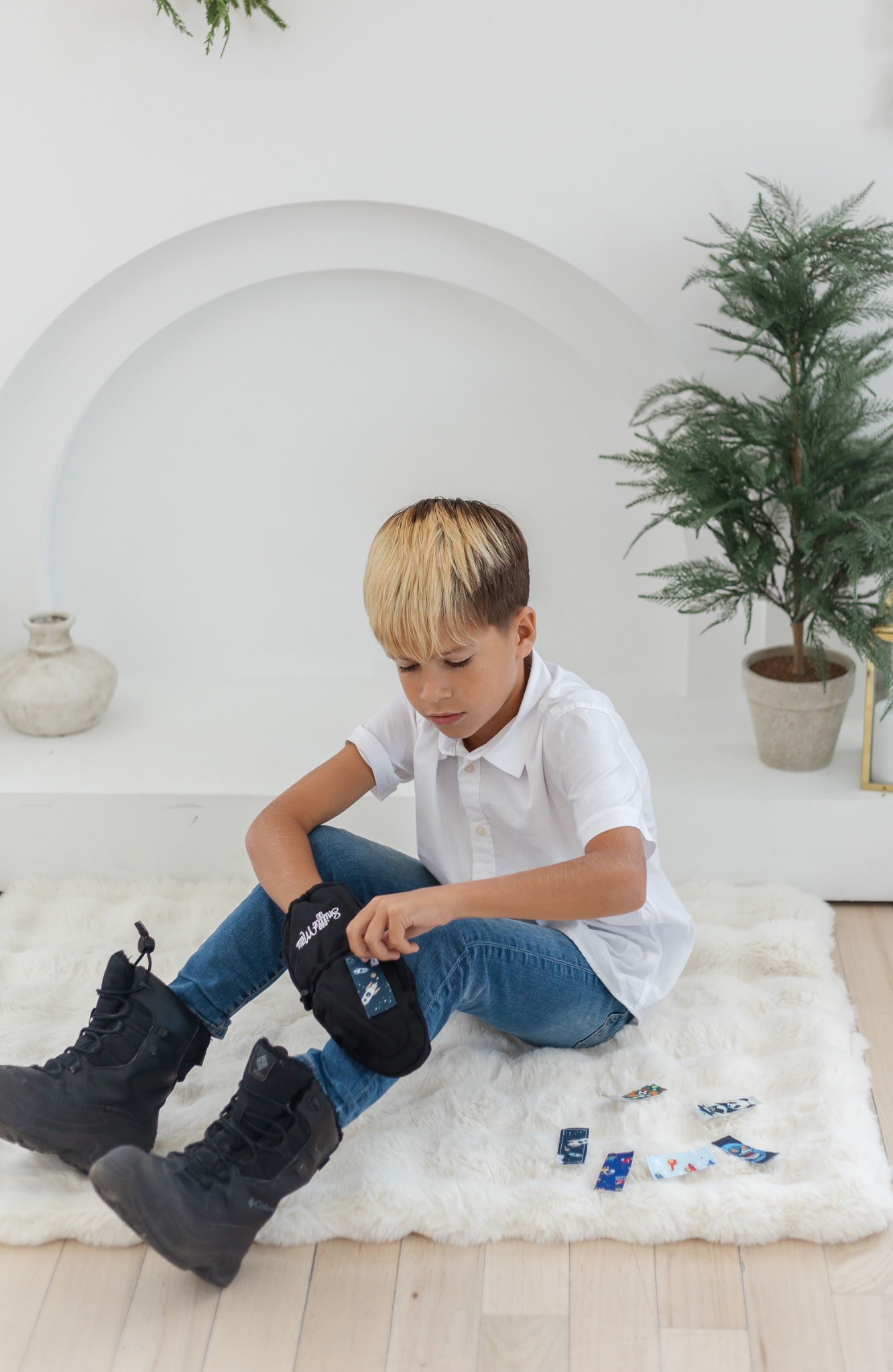 Child placing a SniffleMitts strip